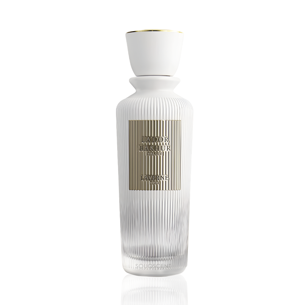 A tall, ribbed glass perfume bottle with a white ceramic cap and a metallic gold label, shown on a clean white background with a subtle reflection.