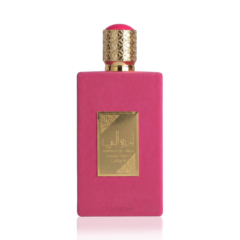 A rectangular pink perfume bottle with a textured gold cap and a gold label on the front, photographed against a clean white background.