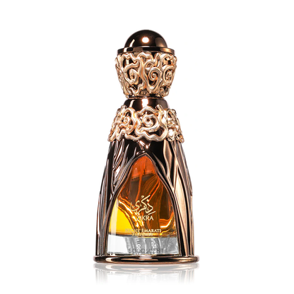 Decorative perfume bottle with intricate design on a white background