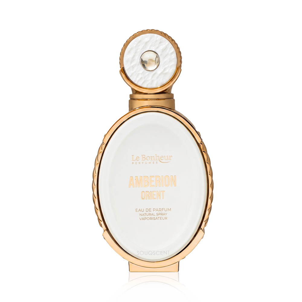 Le Bonheur Parfums Amberion Orient Eau de Parfum bottle, featuring a gold-plated oval frame and cap with a textured white interior and a central clear crystal, set against a solid white background.