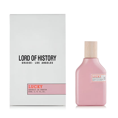 Pink perfume bottle with wooden cap and 'Lucky' label next to a white box with 'Lord of History' branding.
